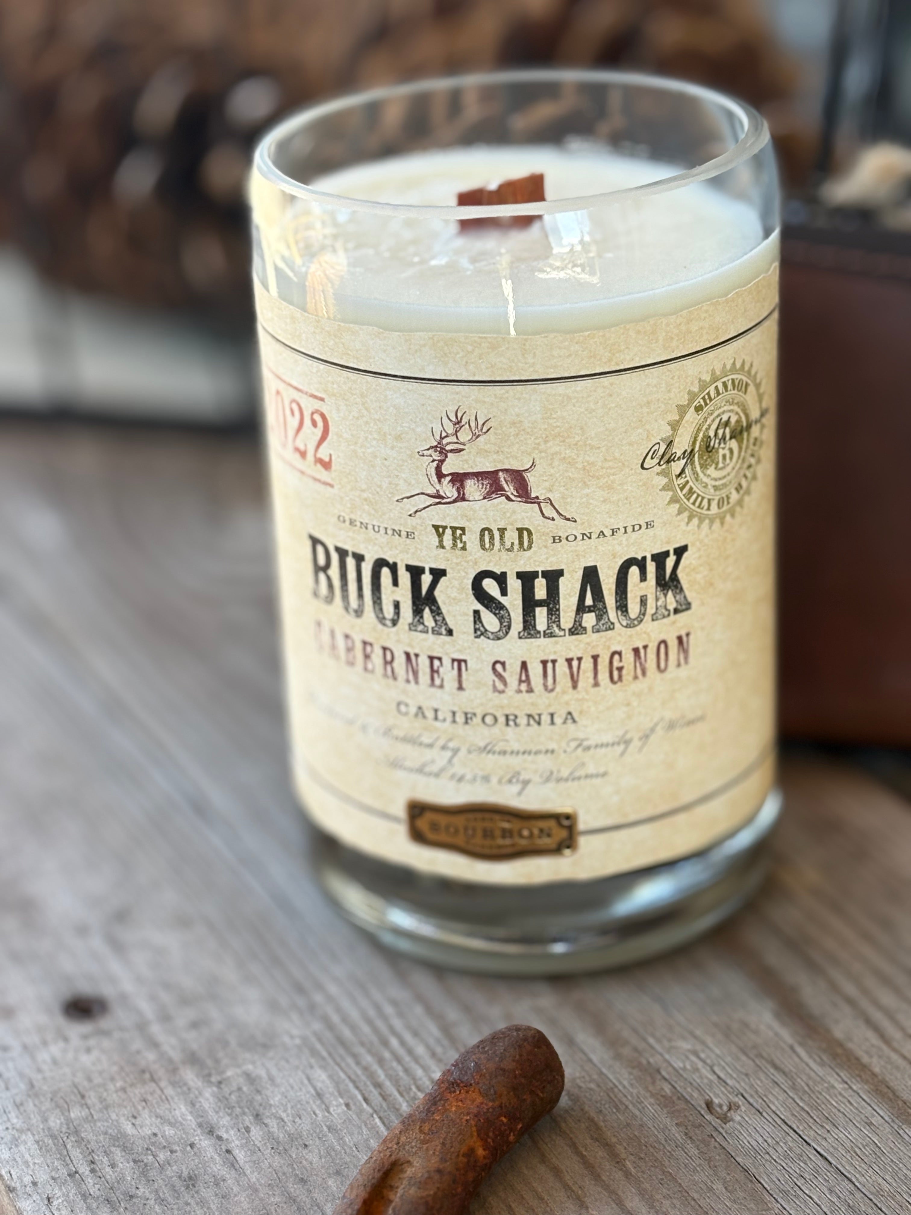 rugged western white candle made from an old wine bottle, label reads "buck shack cabernet sauvignon"
